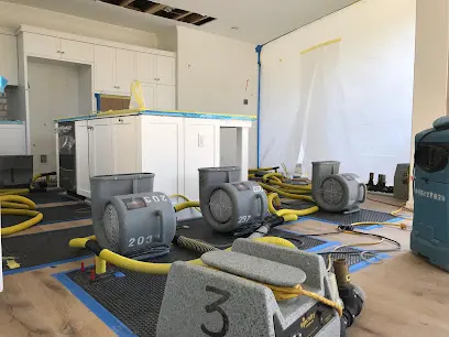 Air movers drying a great room after a storm leak in Laguna Hills
