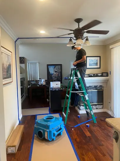 Air movers and a ladder drying a Laguna Hills kitchen