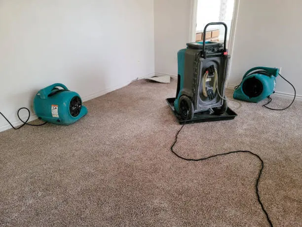 Air movers and a dehumidifier drying a Laguna Hills, CA home interior